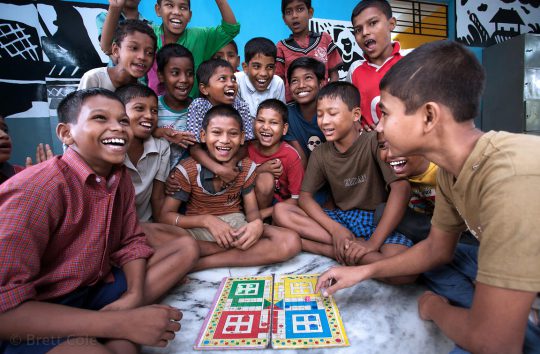 Children play Pachisi, or Cross and Circles, a traditional Indian board game that is the basis for the well-known board game Parcheesi, at a shelter in Calcutta, India